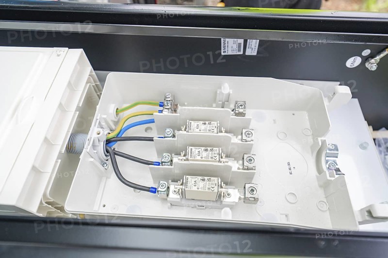 Interior view of a switch box with organised cables and fuses, installation of a charging station for electric cars, Calw, Germany