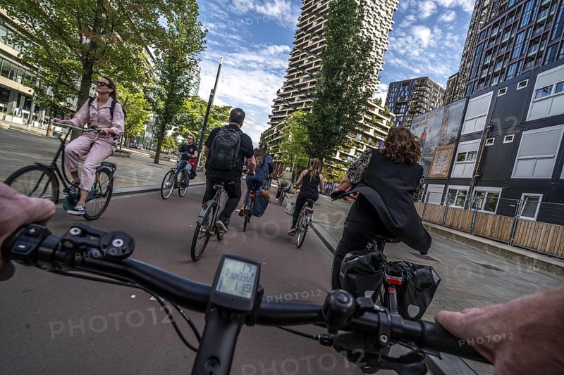 Cycle along the Jaarbeursplein, south of Utrecht Central, HBF, on the central cycle path in the city centre of Utrecht, lanes for pedestrians, cyclists and vehicles are separated, heavy cycle traffic, Netherlands