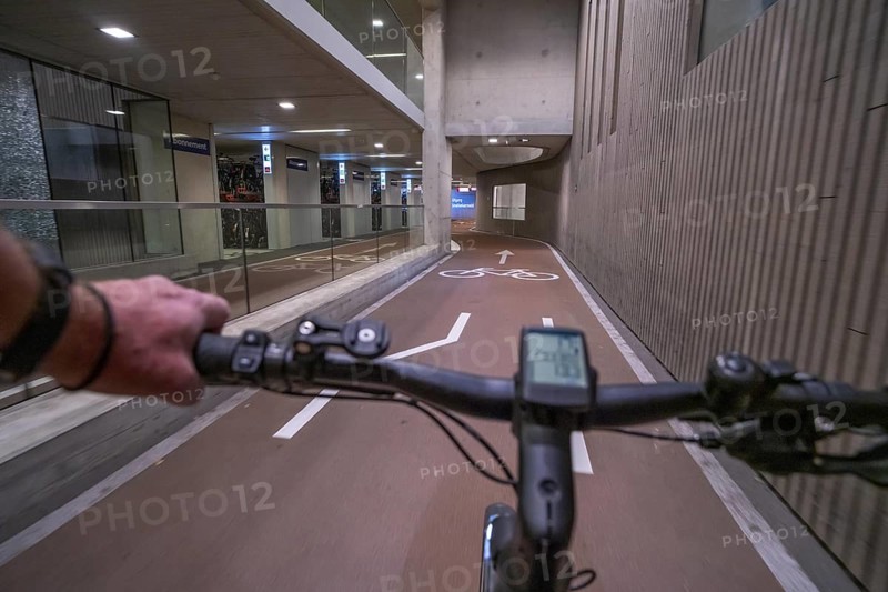 Ride your bike into and out of the bicycle car park at Utrecht Centraal station, Stationsplein, over 13, 000 parking spaces, considered the largest bicycle car park in the world, over 3 underground floors, Utrecht, Netherlands