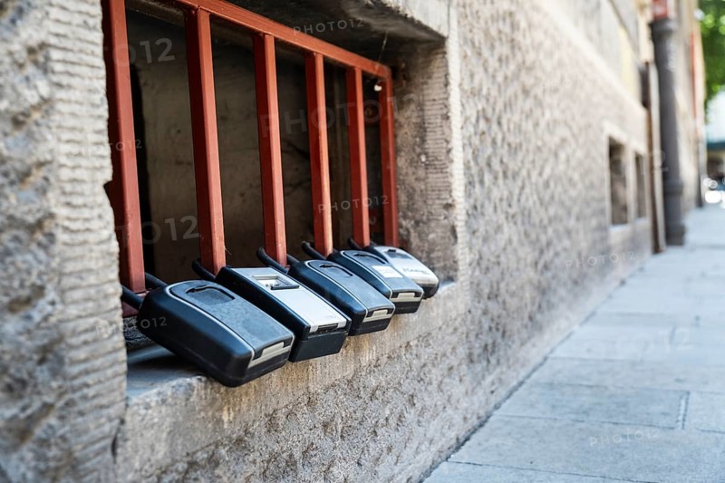 Key boxes on a grille of a basement window for flat flats in the city centre of Bratislava, Slovakia