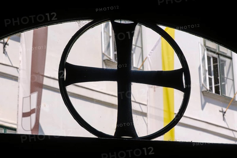 Black paw cross in the skylight of the entrance to the Deutschordenshaus in Vienna, Austria, for editorial use only