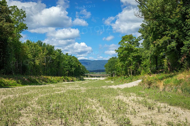 Wide dry riverbed of the Schwarza with a view of mountains, Neunkirchen, Lower Austria, Austria