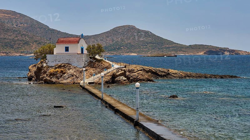 Whitewashed chapel with red roof on island in blue sea under sunny sky, chapel, church, Agios Isidoros, rocky islet, bay of Gourna, Kokkali, Leros, Dodecanese, Greek Islands, Greece