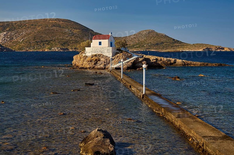 White chapel with red roof on rocky island, accessible via a long footbridge, chapel, church, Agios Isidoros, rocky islet, Bay of Gourna, Kokkali, Leros, Dodecanese, Greek Islands, Greece