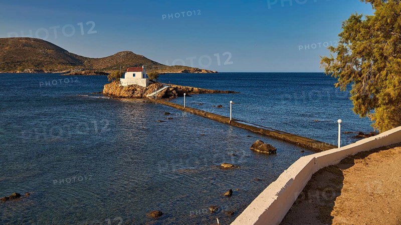 Small chapel on rock, surrounded by trees, in quiet morning light, chapel, church, Agios Isidoros, rocky islet, Bay of Gourna, Kokkali, Leros, Dodecanese, Greek Islands, Greece