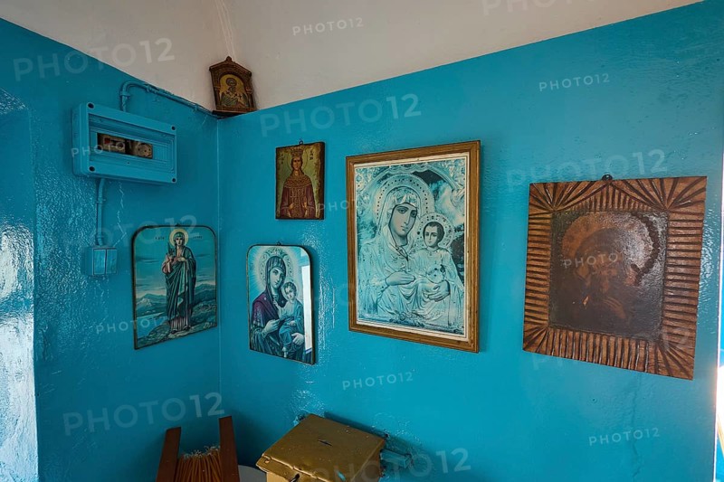 A room decorated with icons and blue-painted walls inside the church, chapel, church, Agios Isidoros, rocky islet, Gourna Bay, Kokkali, Leros, Dodecanese, Greek Islands, Greece