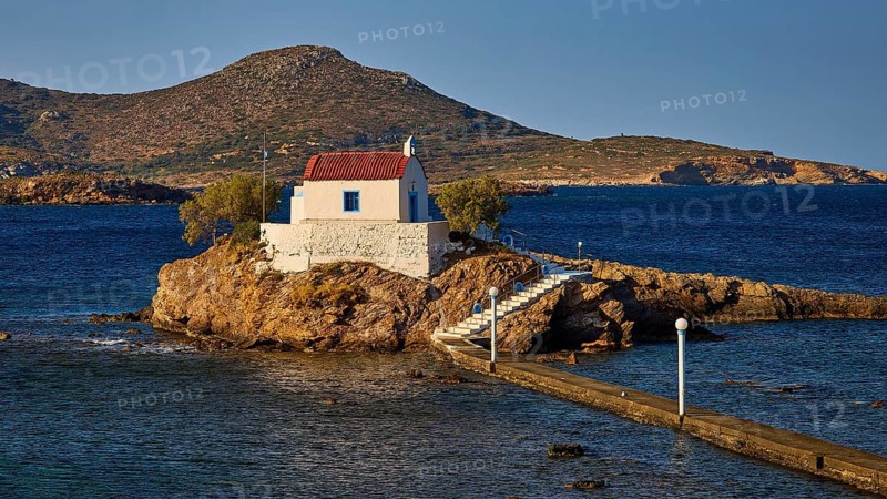 Chapel on rocks as the landscape is bathed in warm light, Chapel, Church, Agios Isidoros, Rocky islet, Bay of Gourna, Kokkali, Leros, Dodecanese, Greek Islands, Greece