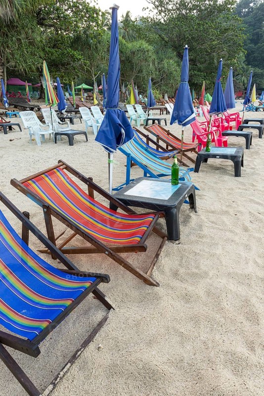 Abandoned deckchairs and parasol after sunset at Charlie Beach, Koh Mook Island, Andaman Sea, Thailand, Southeast Asia