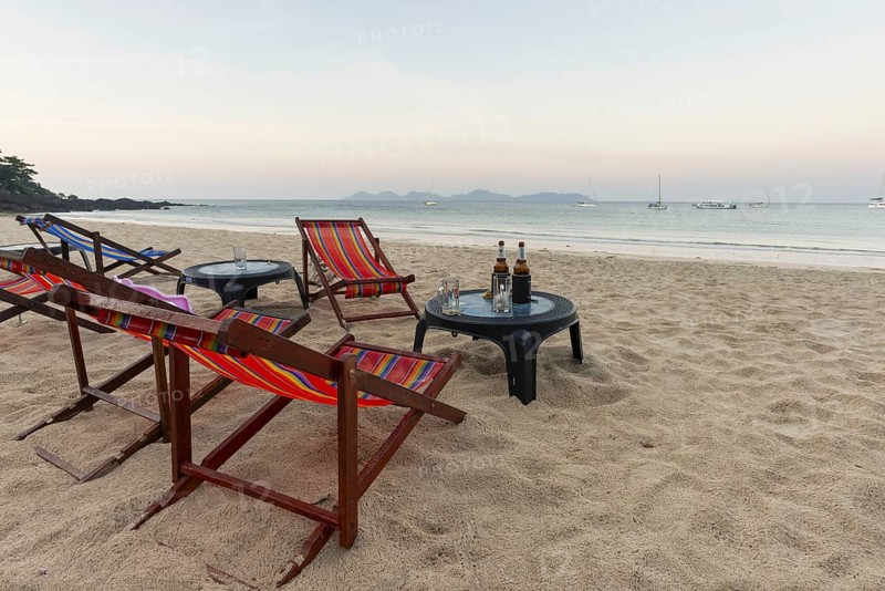 Abandoned deckchairs and parasol after sunset at Charlie Beach, Koh Mook Island, Andaman Sea, Thailand, Southeast Asia