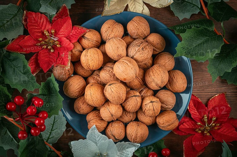 Blue plate with walnuts decorated with Christmas decoration