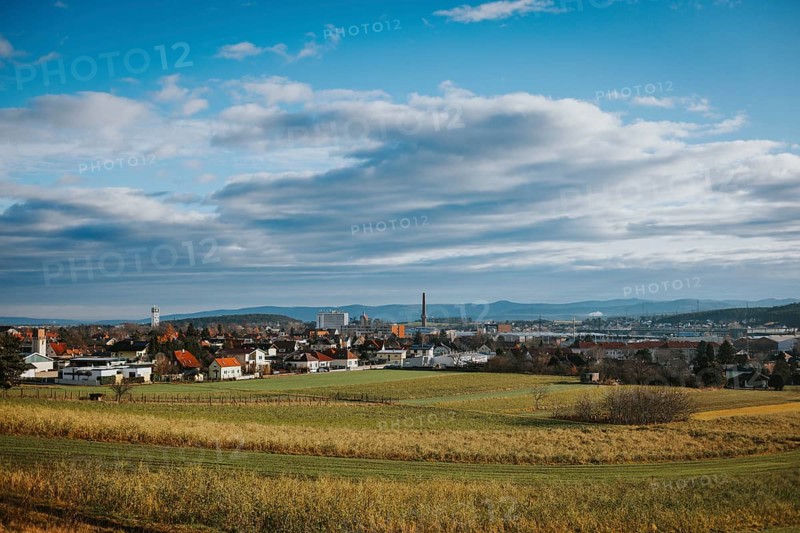 Panorama with city, fields and mountains under variable sky, Ternitz, Lower Austria, Austria