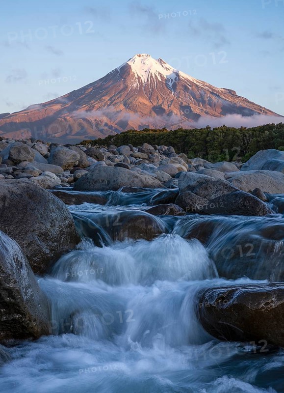 Mount Taranaki in the evening at sunset, in the foreground Stony River (Hangatahua River) . Egmont National Park, Taranaki Region, North Island, New Zealand