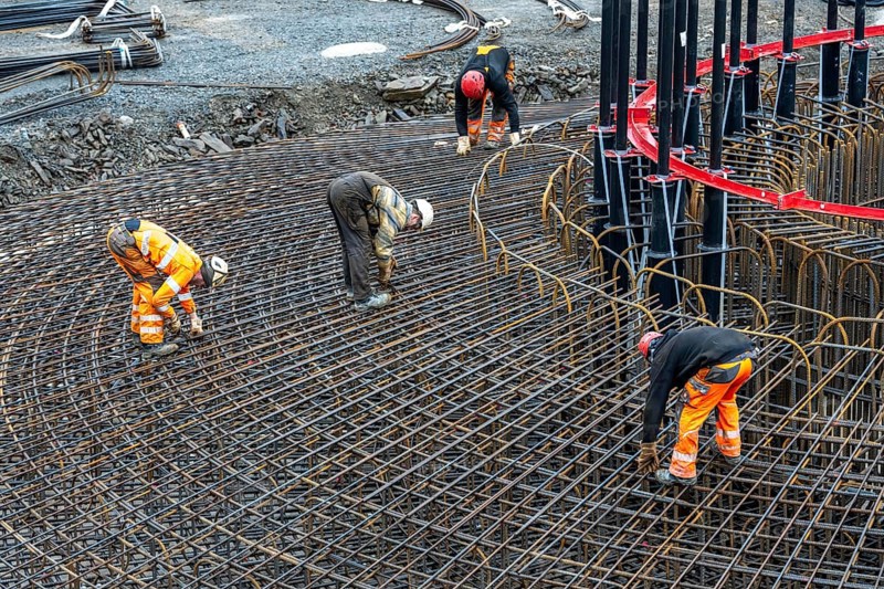 Assembly of reinforcing steel for the reinforced concrete foundation of a wind turbine, a mesh of rebar and reinforcing steel mesh, connecting the steel elements with binding wire, twisting with tongs, over 100 tons of reinforcing steel were used, the wind turbine will have a hub height of 160 meters, part of a new wind farm in Sauerland, near Balve, North Rhine-Westphalia, Germany