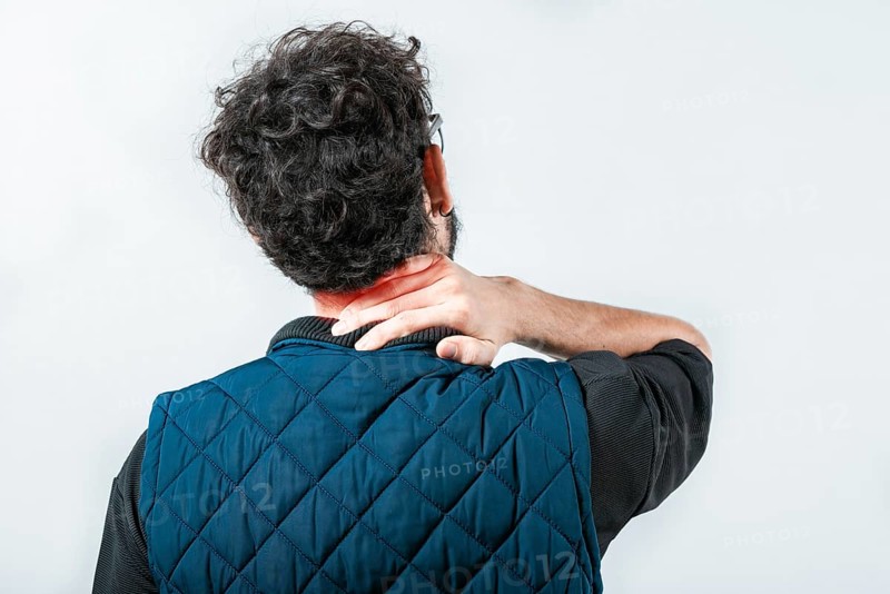 Close up of person with neck pain. Concept of people with stress and neck pain