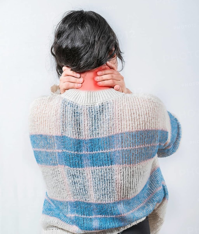 Close up female with neck pain. Woman in pain holding her neck isolated. Suffering woman with stress and neck pain