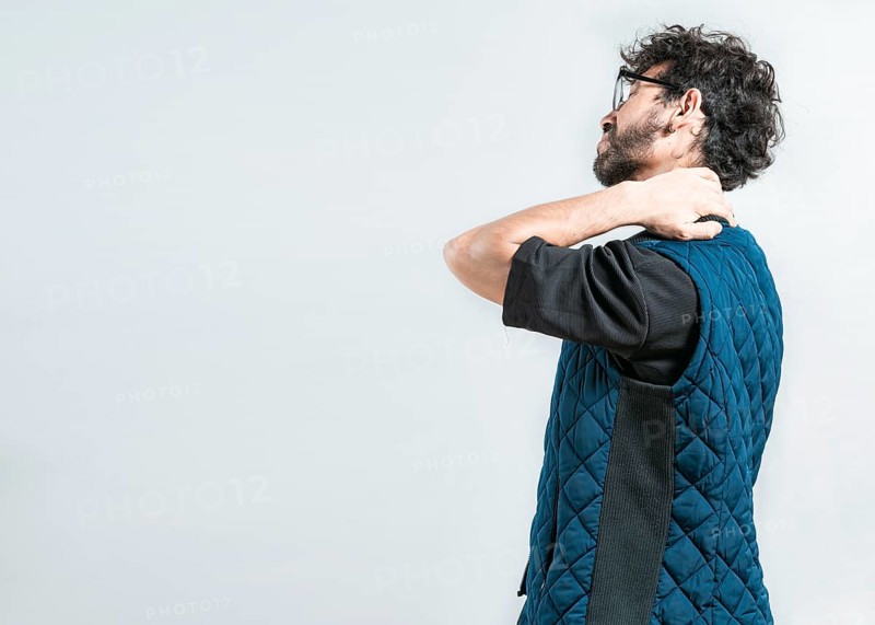 Suffering young man with stress and neck pain. Fatigued man with neck pain isolated
