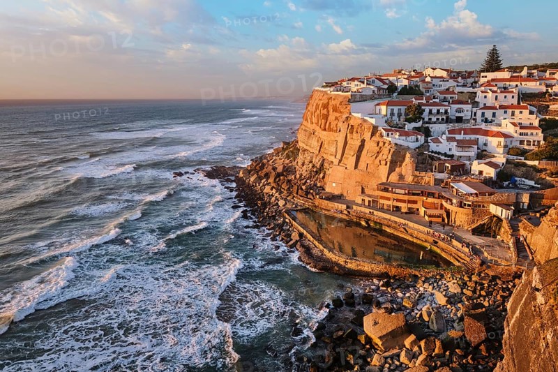 Scenic view of the seaside Azenhas do Mar fishing village on cliff on Atlantic ocean coast, Portugal on sunset