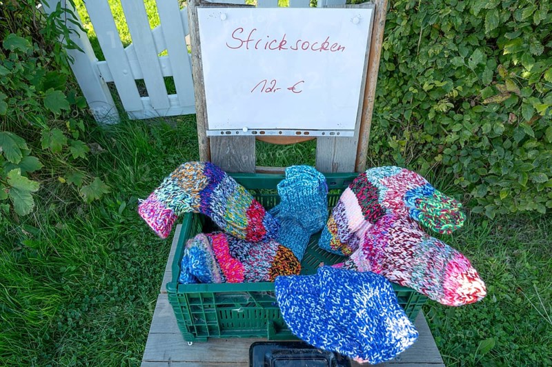 Sales stand with knitted socks on a path on the Bodden, Ahrenshoop, DarÃŸ, Mecklenburg-Western Pomerania, Germany