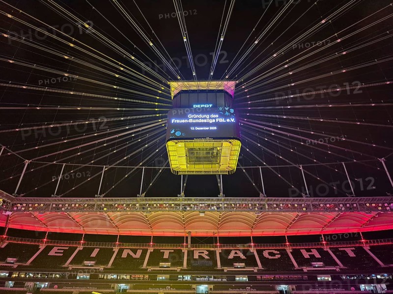 The Frankfurt Waldstadion (Deutsche Bank Park) is illuminated in red to mark the founding of the Women's Bundesliga Association and the video cube reads: Founding of the Women's Bundesliga FBL e.V. - 10 December 2025, Waldstadion, Frankfurt am Main, Hesse, Germany