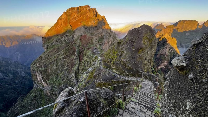 Sunrise at Pico do Arieiro, clouds of fog pass over mountain peaks, hiking trail PR1, Madeira, Portugal