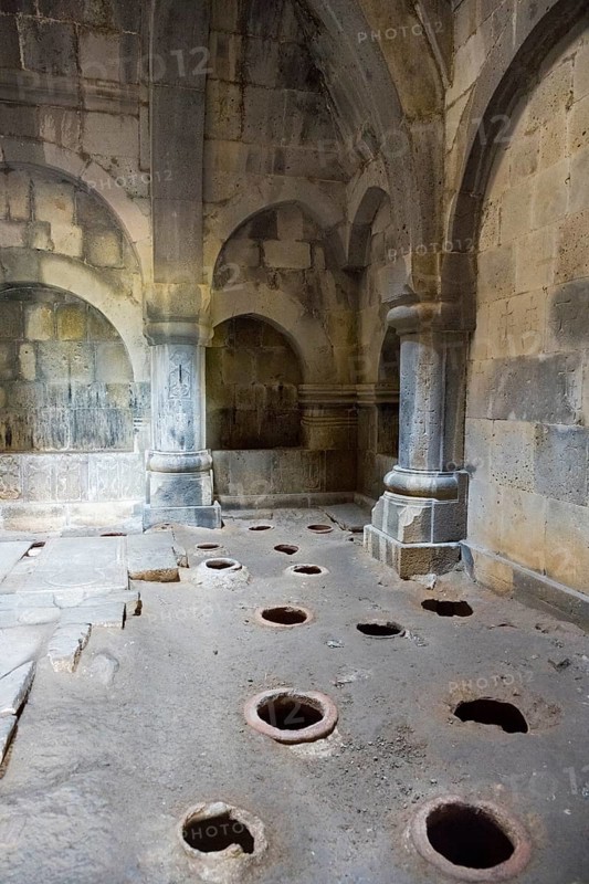 Stone room with large floor holes and massive pillars surrounded by weathered walls, Haghpat Monastery, Haghpatavank, Haghpat town, UNESCO World Heritage Site, Lorikeet Province, Armenia