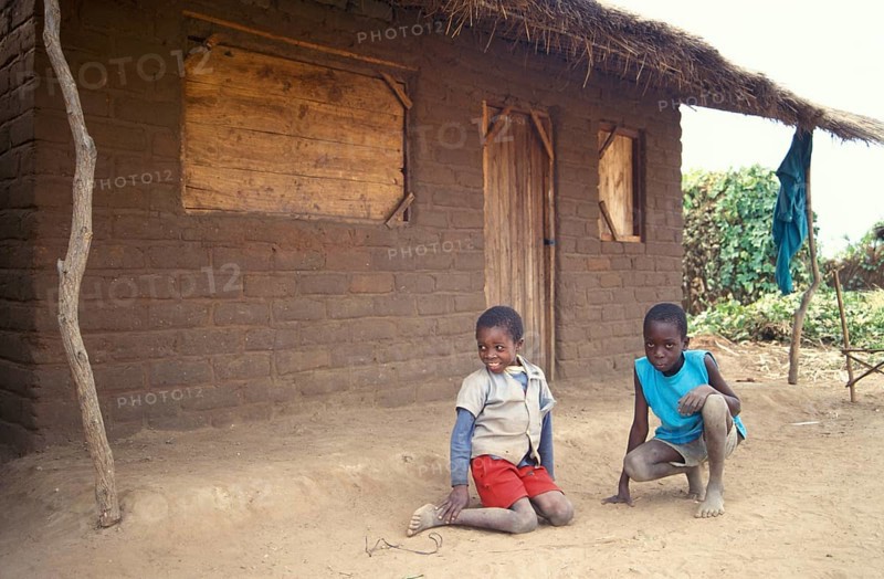 Children in front of a clay hut on the side of the road, boys, Salima, Malawi, Africa, June 2000, vintage, retro, old, historic