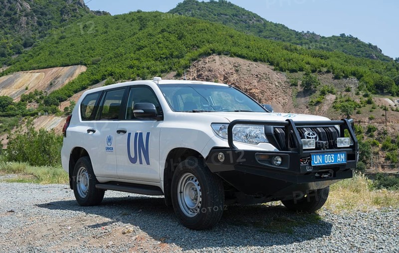 White UN SUV parked in front of a natural mountain landscape, Toyota of UNHCR, The UN Refugee Agency, Lorikeet Province, Armenia