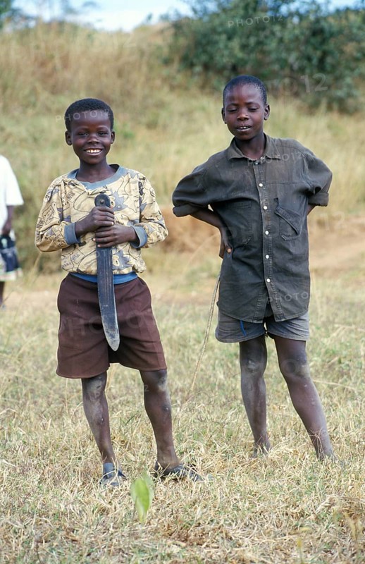 Portraits of two boys, one of them holding a large knife, Bwangu Mzimba, Malawi, Africa, June 2000, vintage, retro, old, historical