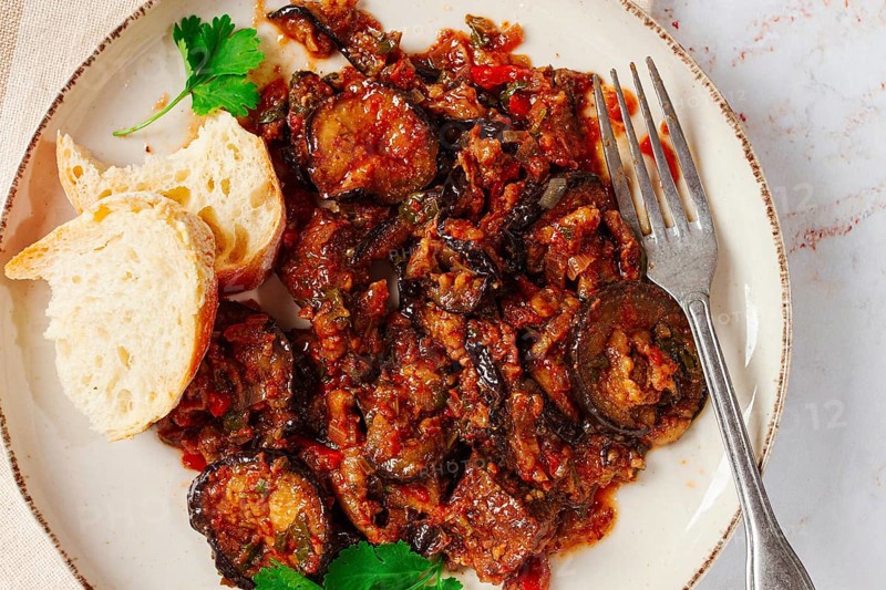 Stewed meat with eggplant is a Georgian dish, on a light background, homemade, no people