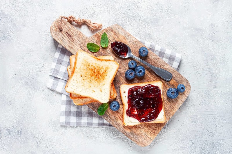 Toast with blueberry jam, on a wooden chopping board, breakfast, homemade, no people