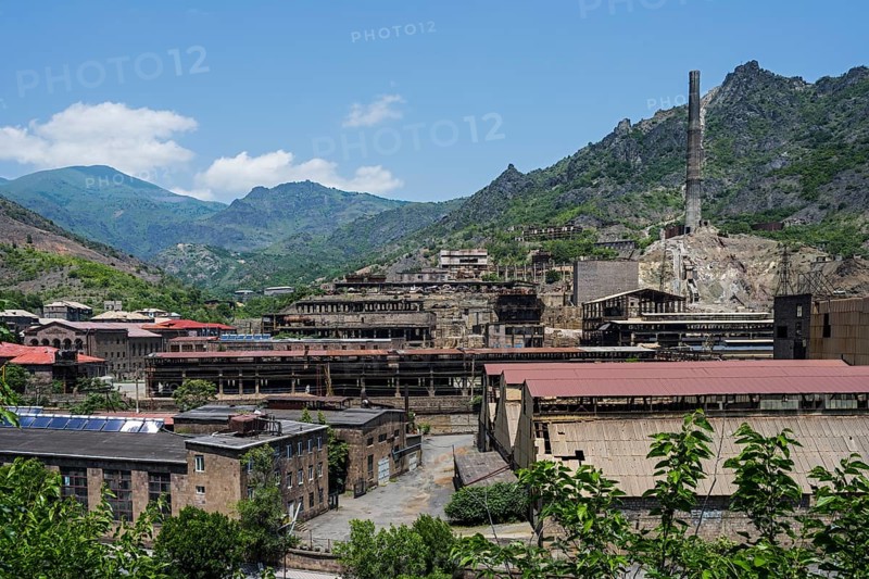 Industrial plant in a mountainous area with old buildings and chimney surrounded by green hills, former copper smelter, Alaverdi, Alaverdi, Lorikeet province, Armenia