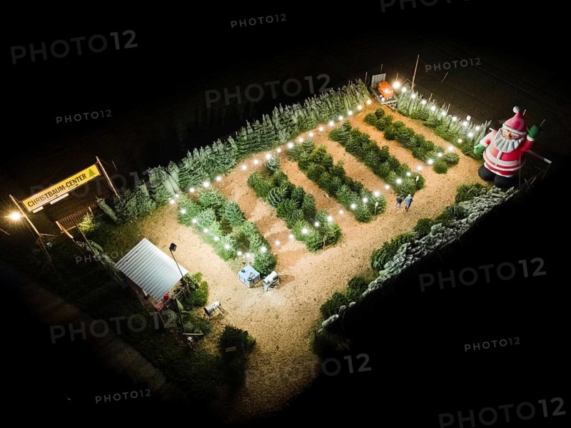 In a Christmas tree centre near Frankfurt am Main there is a decorative inflatable figure of Father Christmas several metres high. (Aerial photo taken with a drone), Frankfurt am Main, Hesse, Germany