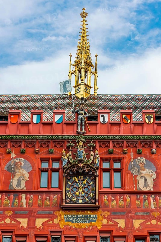 Exterior view with a magnificent clock at the Red Town Hall, Market Square, Basel