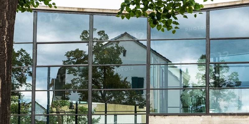 House is reflected in glass faÃ§ade, architecture, reflection