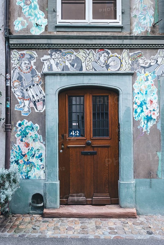 House faÃ§ade with paste-up street art, Basel