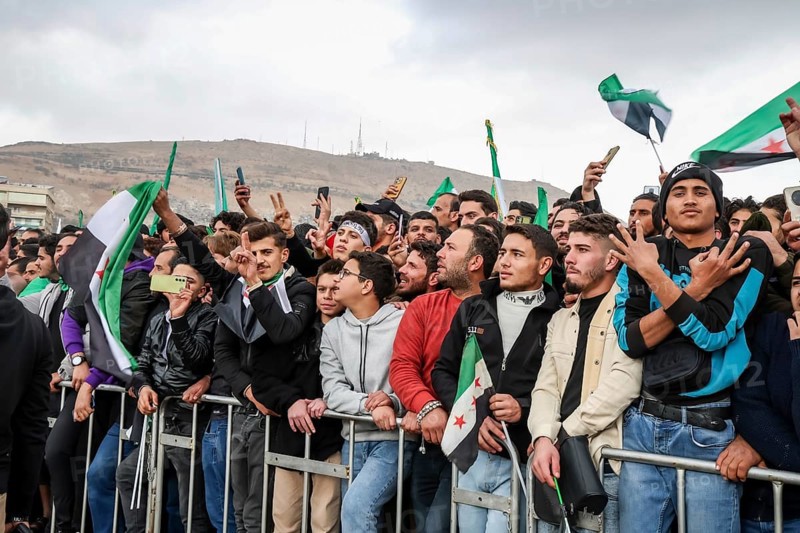 Damascus, Syria â€“ December 08, 2025: Thousands of Syrians gather in the iconic Umayyad Square in central Damascus, raising Syrian flags to celebrate the first anniversary of the fall of the Assad regime and the end of a brutal 14-year war that claimed hundreds of thousands of lives, Damascus, Damascus, Syria