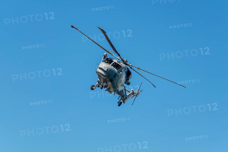 Military helicopter in blue sky