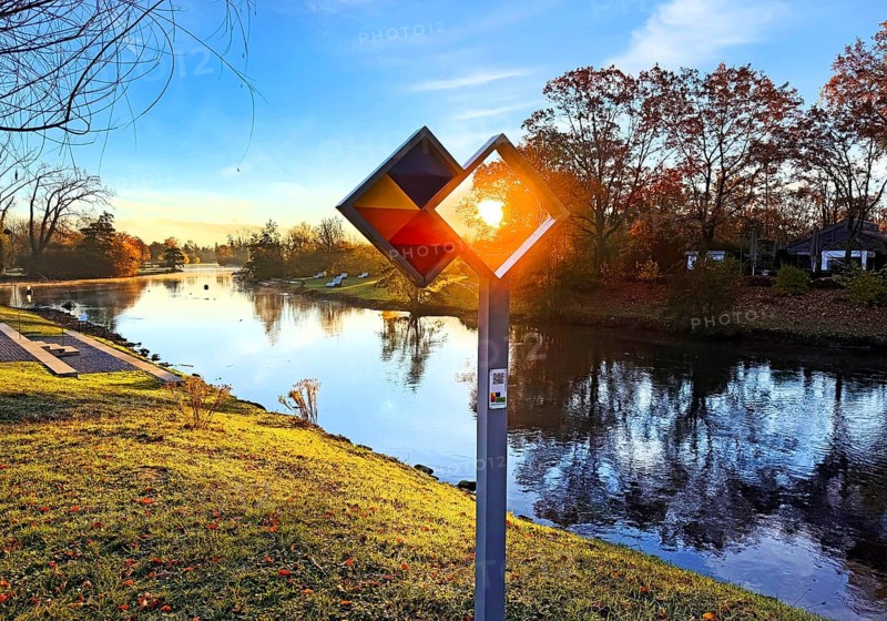 Sunrise over the Lippe river with the sign of the discovery route Wasser Wege Winkel, Lippeaue, Lippstadt, North Rhine-Westphalia, Germany