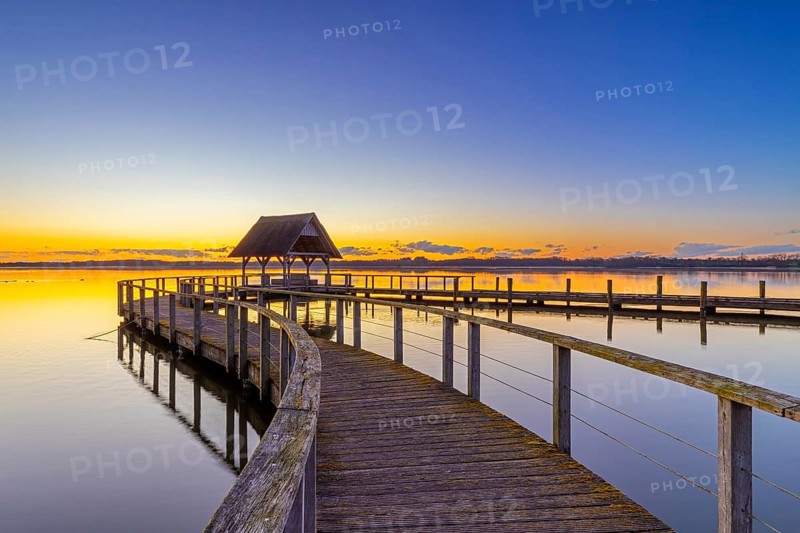 Wooden jetty on Lake Hemmelsdorf / Hemmelsdorfer See at sunrise in spring near LÃ¼beck, Schleswig-Holstein, Germany