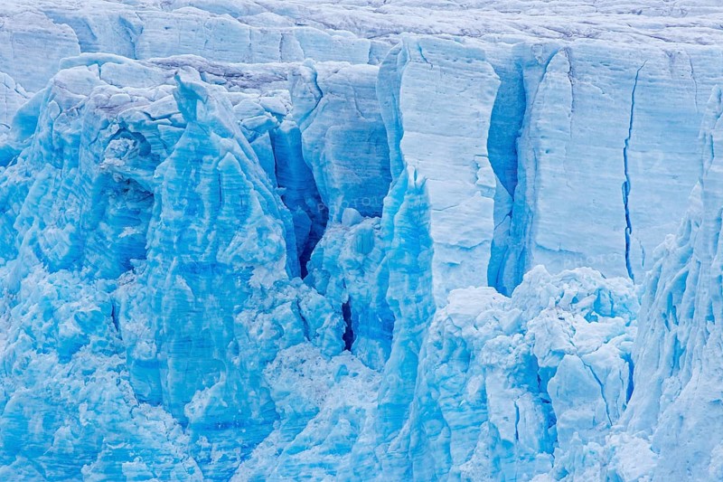Calving glacier wall showing crevasses, deep cracks in blue ice, Lilliehöök Fjord, Krossfjorden in Albert I Land, Spitsbergen, Svalbard