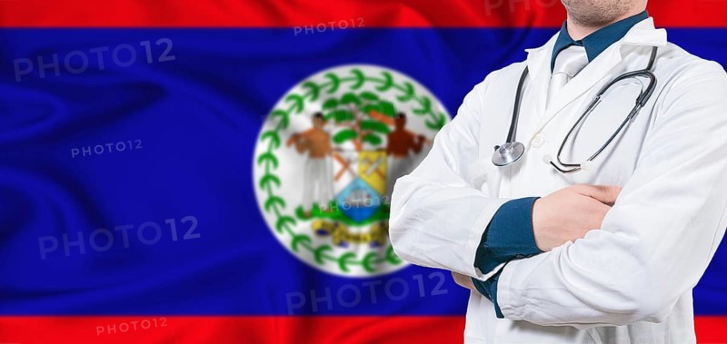 Belize healthcare concept. Male doctor on Belizean flag. Doctor with crossed arms on Belize flag
