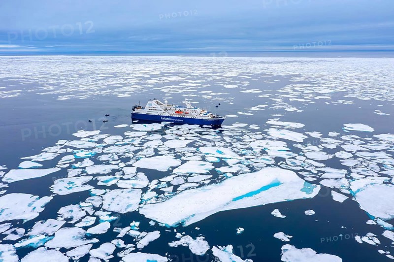 Aerial view over cruise ship Ocean Diamond from Iceland Pro Cruises sailing among drift ice / brash ice in the Arctic Ocean at Svalbard / Spitsbergen