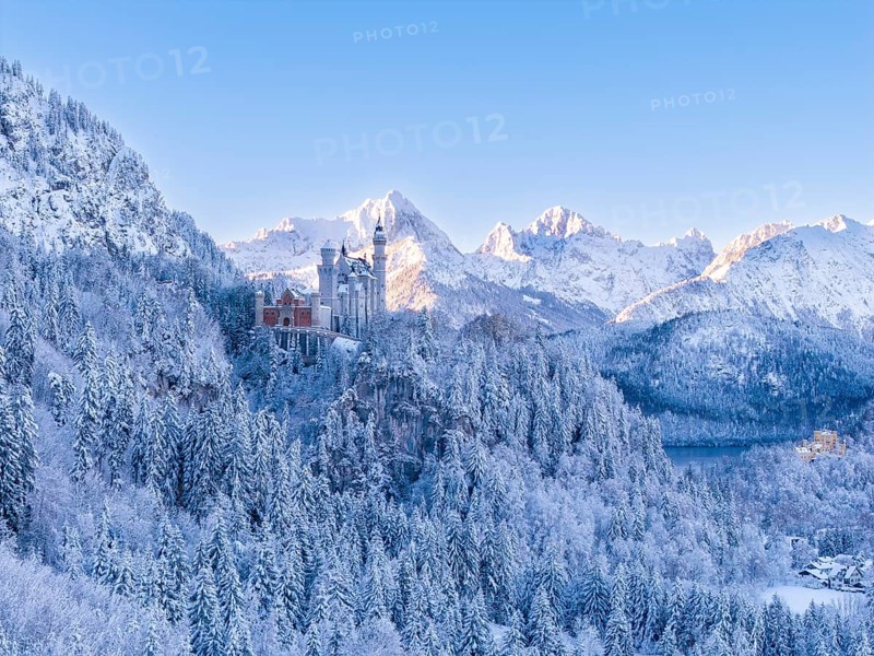 Impressive winter image of Neuschwanstein Castle surrounded by snow-covered mountains and trees. Sense of cold and grandeur, Schwangau near FÃ¼ssen, OstallgÃ¤u, AllgÃ¤u, Bavaria, Germany