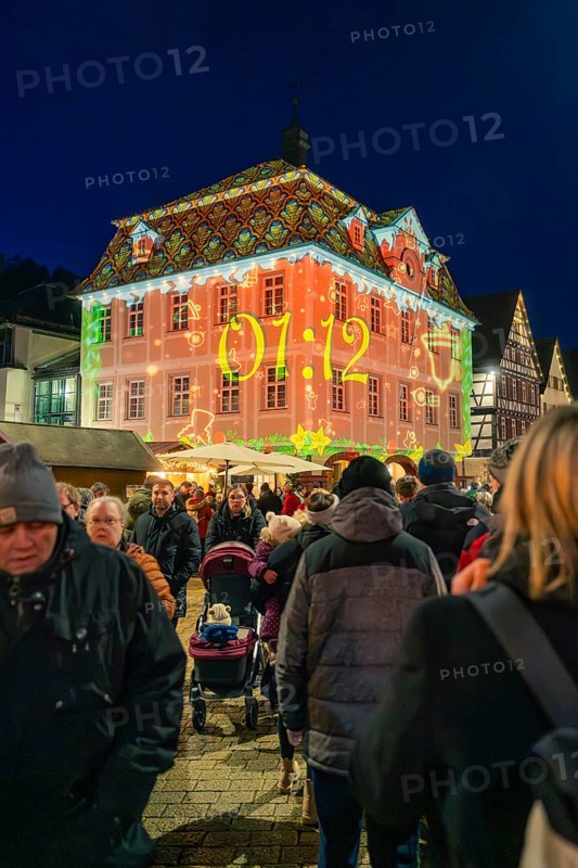Projection with time on a building during a night-time Christmas market, Christmas market 2025, Nagold, Black Forest, Calw district, Germany