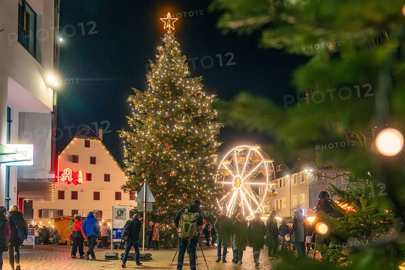 A large festively illuminated Christmas tree and a Ferris wheel light up the night, Christmas market 2025, Nagold, Black Forest, Calw district, Germany
