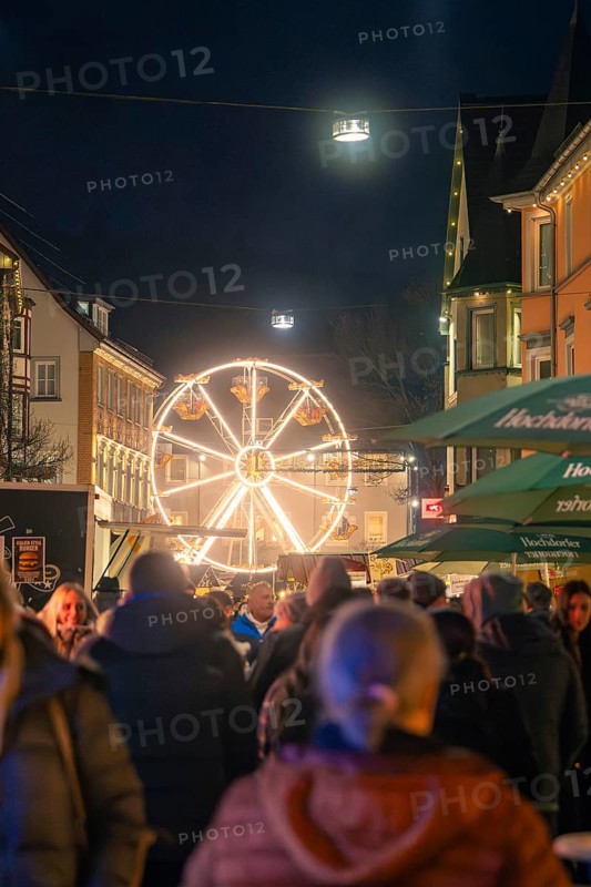 An illuminated Ferris wheel on a night-time Christmas market full of people, Christmas market 2025, Nagold, Black Forest, Calw district, Germany
