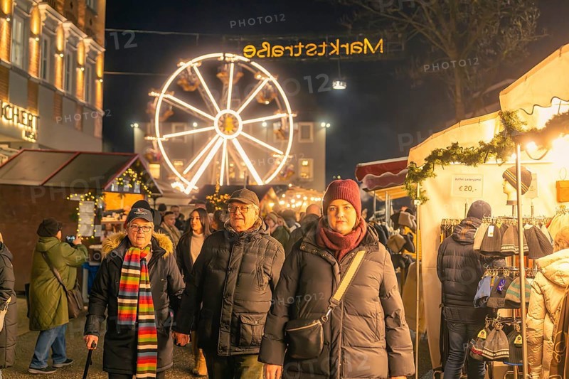 People stroll through an illuminated market with a large Ferris wheel in the background, Christmas market 2025, Nagold, Black Forest, Calw district, Germany