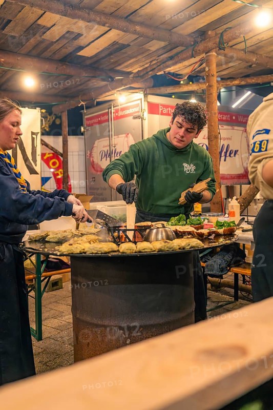 Chefs at the stand prepare fresh pancakes at a Christmas market, Christmas market 2025, Nagold, Black Forest, Calw district, Germany