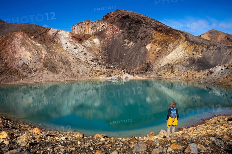A hiker at one of the Emerald Lakes and Red Crater, Panorama, Tongariro alpine crossing, Tongariro National Park, North Island, New Zealand