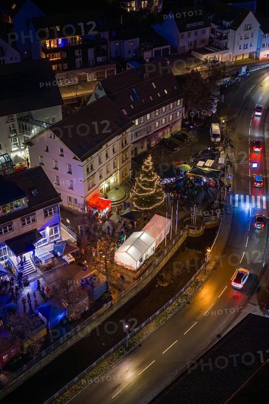 Illuminated street at night with Christmas tree and decorated buildings, Aidlingen Christmas market, Böblingen district, Germany